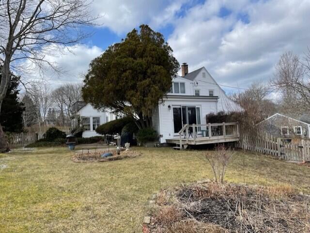 115 Commercial Street, Unit B Wellfleet, MA 02667 - Photo 27 of 37 a view of a house with sitting area and a yard