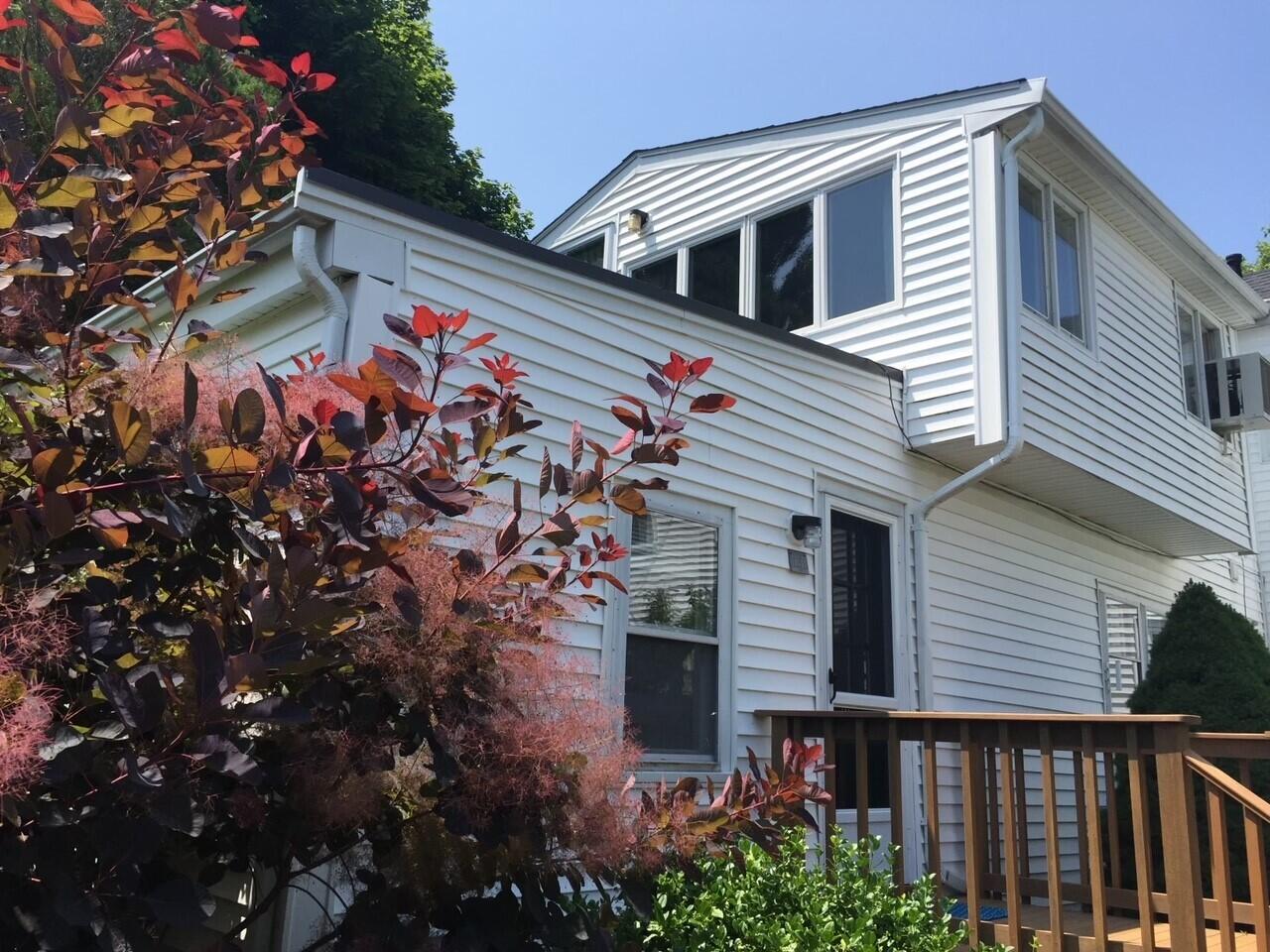 115 Commercial Street, Unit B Wellfleet, MA 02667 - Photo 31 of 37 a front view of a house with balcony