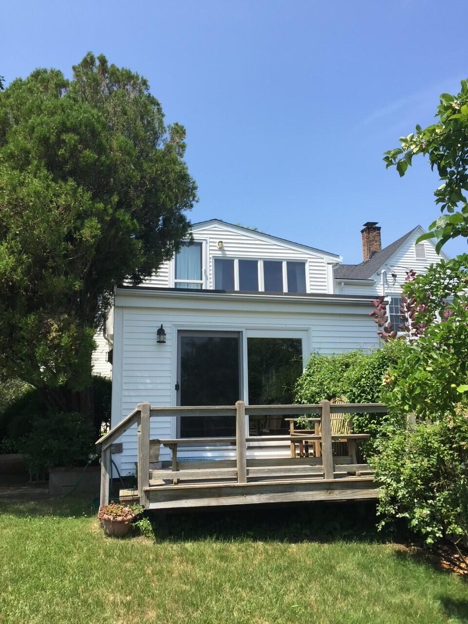 115 Commercial Street, Unit B Wellfleet, MA 02667 - Photo 32 of 37 front view of house with a yard and potted plants
