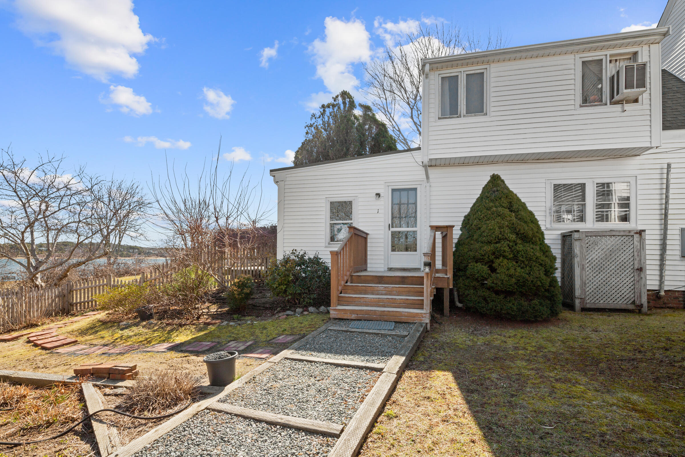 115 Commercial Street, Unit B Wellfleet, MA 02667 - Photo 5 of 37 a view of a house front of a house
