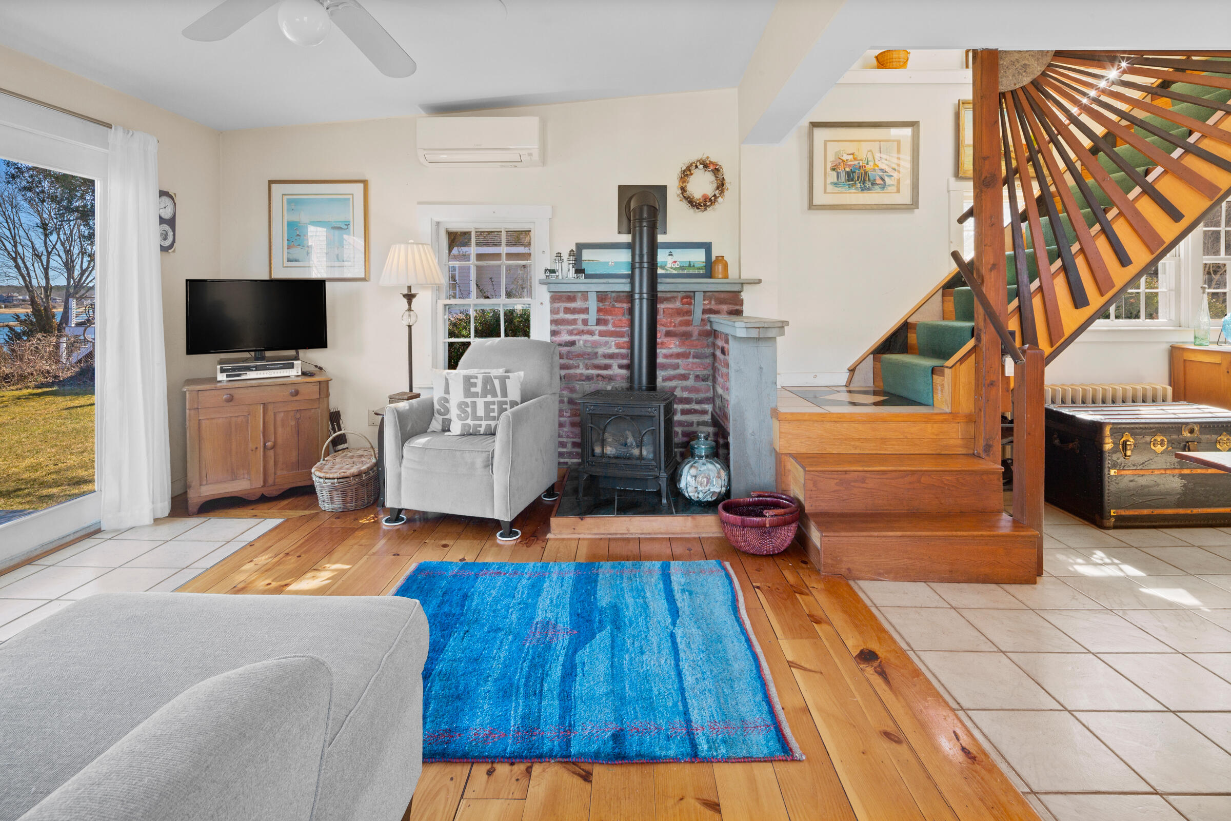 115 Commercial Street, Unit B Wellfleet, MA 02667 - Photo 7 of 37 a living room with furniture and a flat screen tv