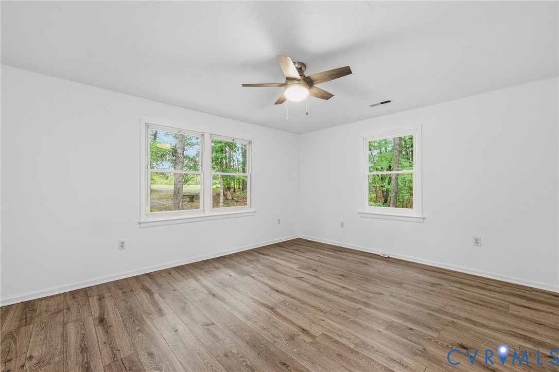 3220 Greenway Road Gladstone, VA 24553 - Photo 7 of 29 a view of an empty room with wooden floor and a window