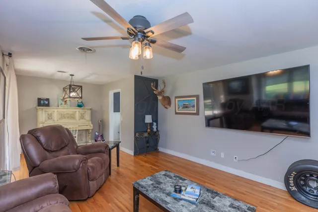 a living room with furniture and a flat screen tv
