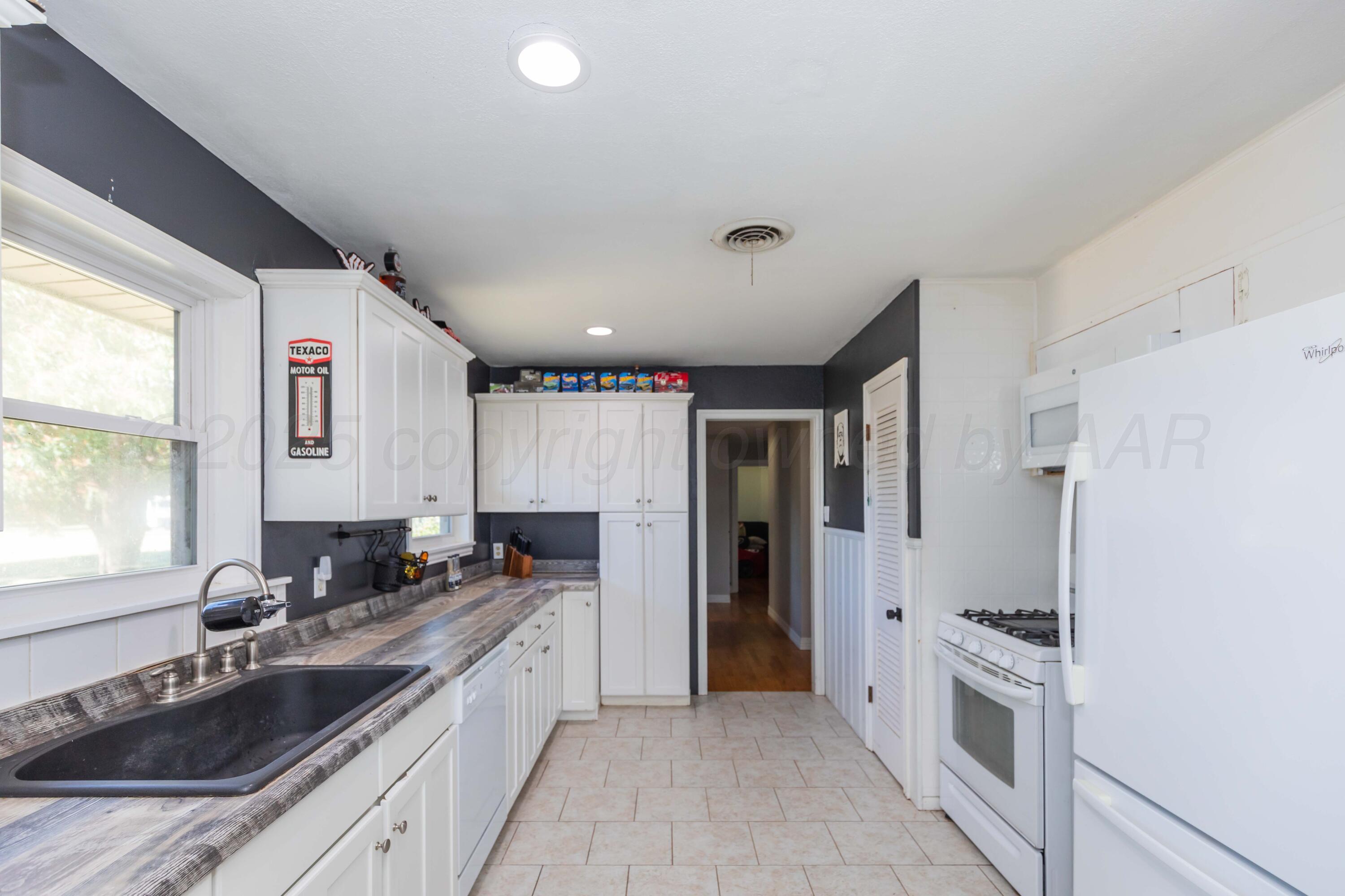 315 Pratt Street Claude, TX 79019 - Photo 15 of 38 a large kitchen with stainless steel appliances granite countertop a lot of counter space and a sink
