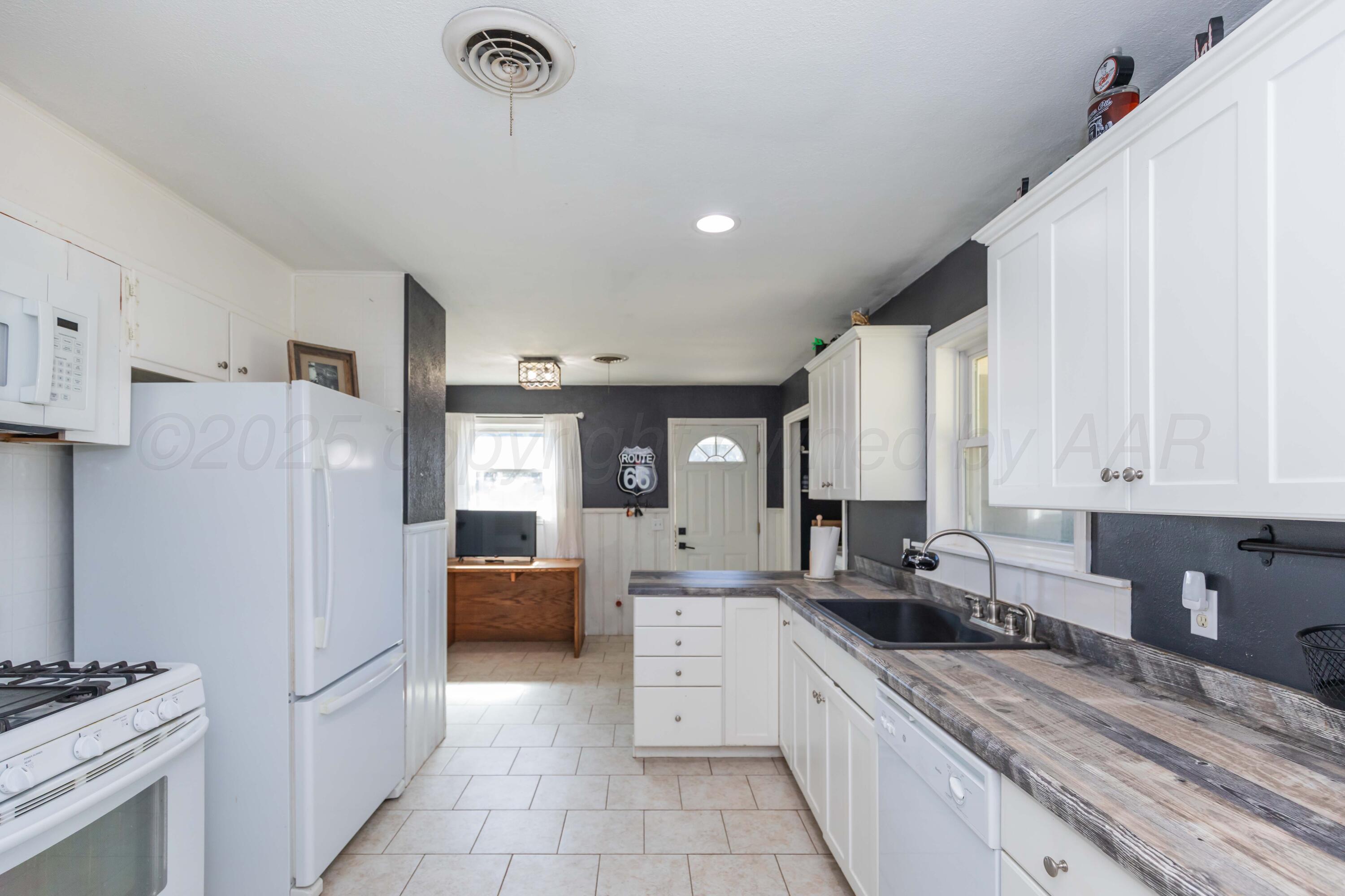 315 Pratt Street Claude, TX 79019 - Photo 16 of 38 a kitchen with stainless steel appliances a refrigerator sink and cabinets