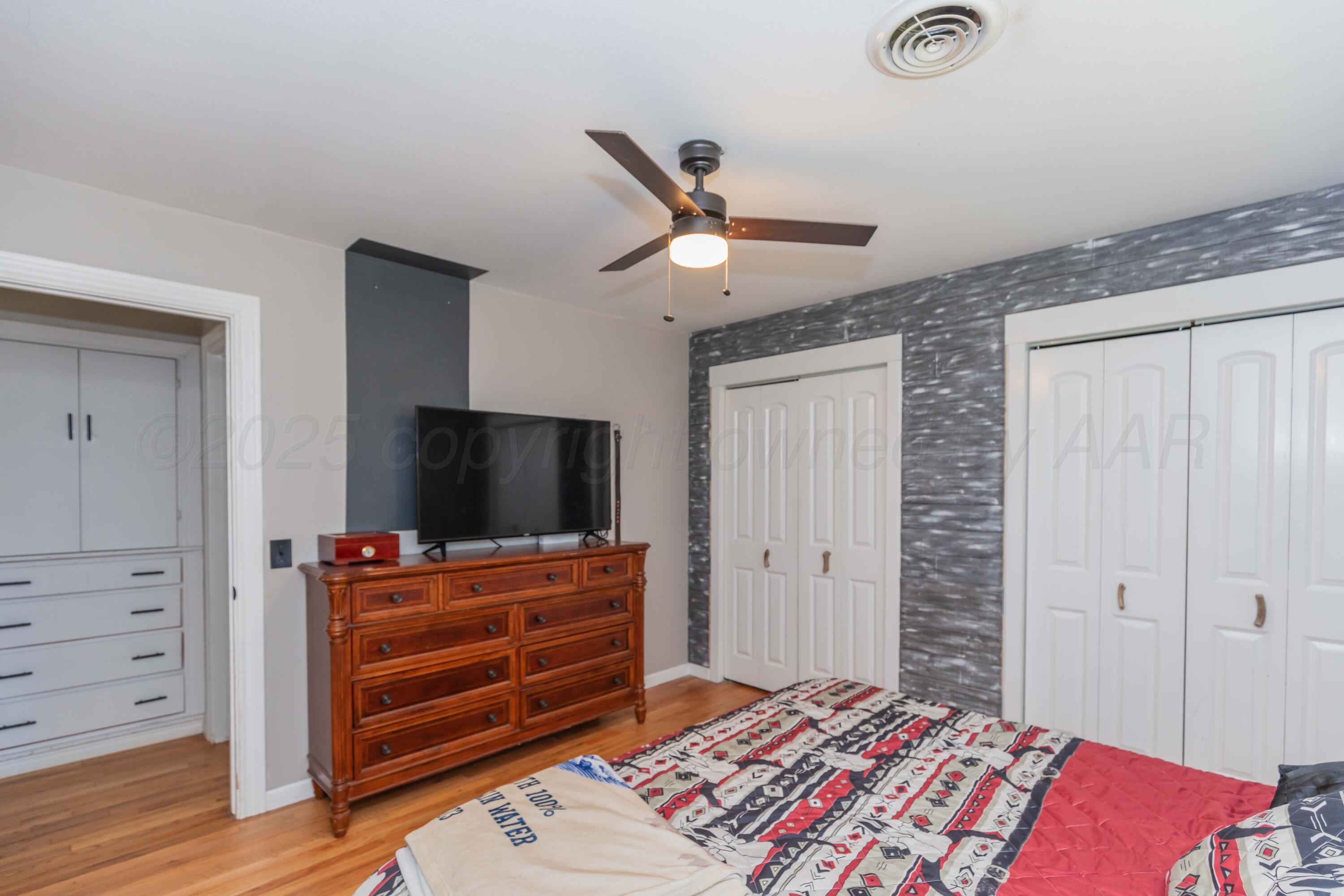315 Pratt Street Claude, TX 79019 - Photo 25 of 38 a bedroom with a bed and flat screen tv