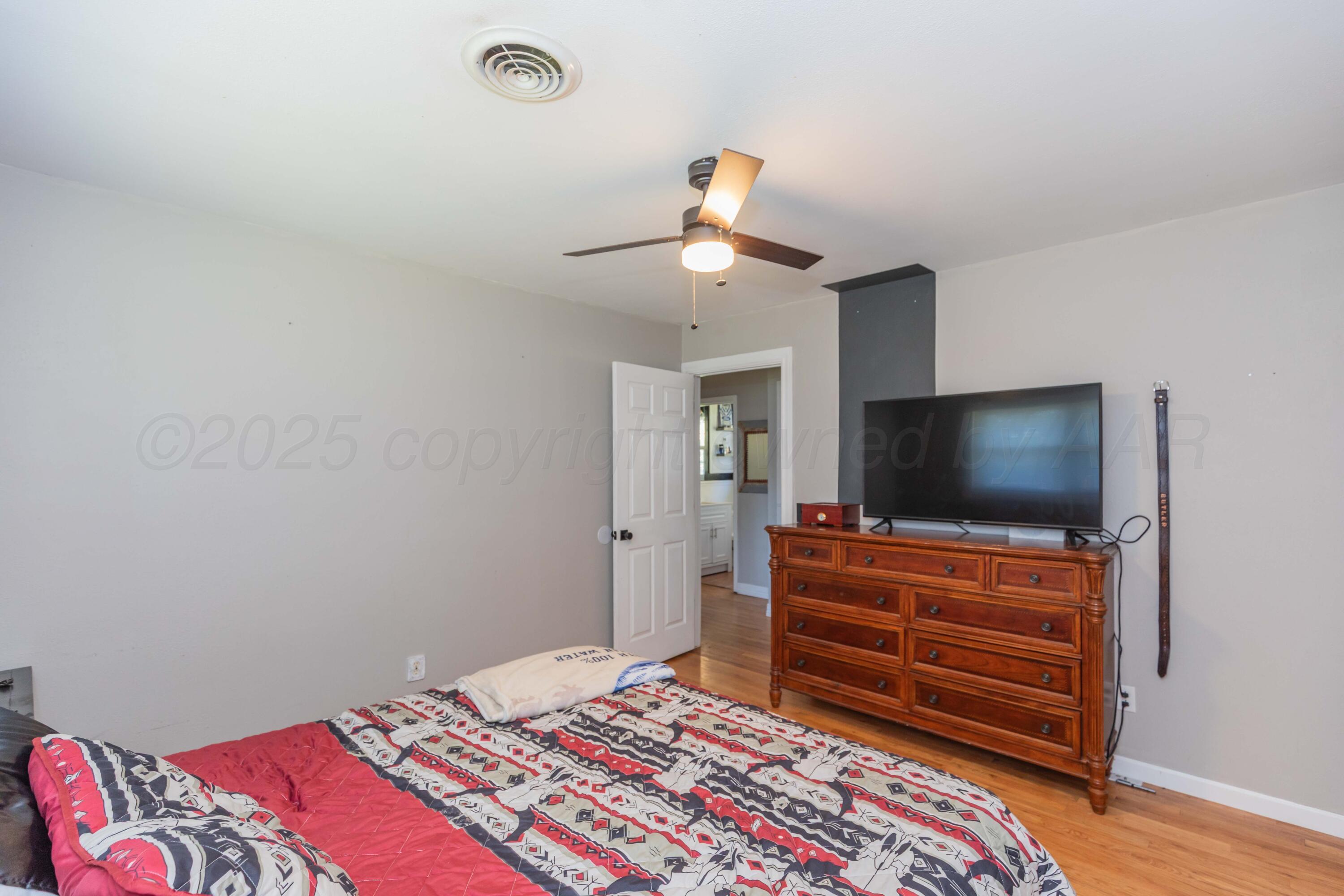 315 Pratt Street Claude, TX 79019 - Photo 26 of 38 a bedroom with a bed and a flat screen tv