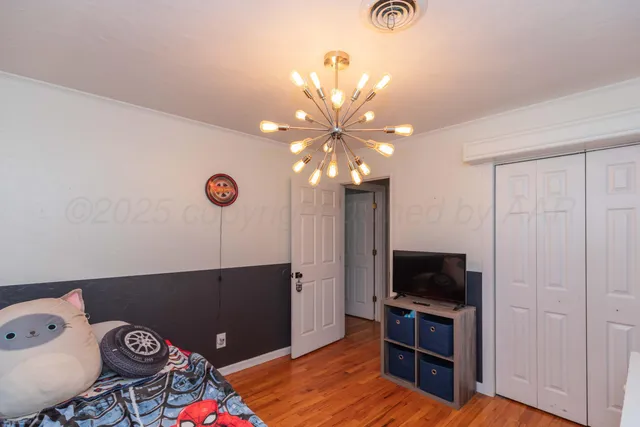 a view of a livingroom with furniture and a flat screen tv