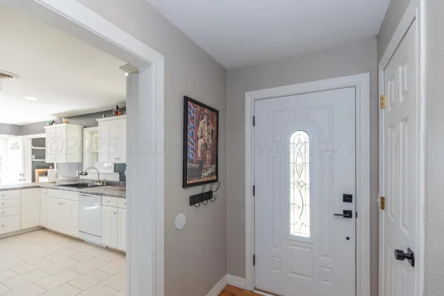 a large white kitchen with cabinets and a sink