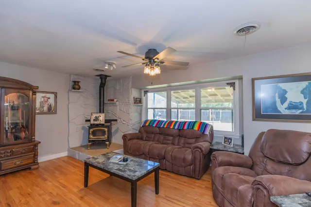 a living room with furniture a rug and a window