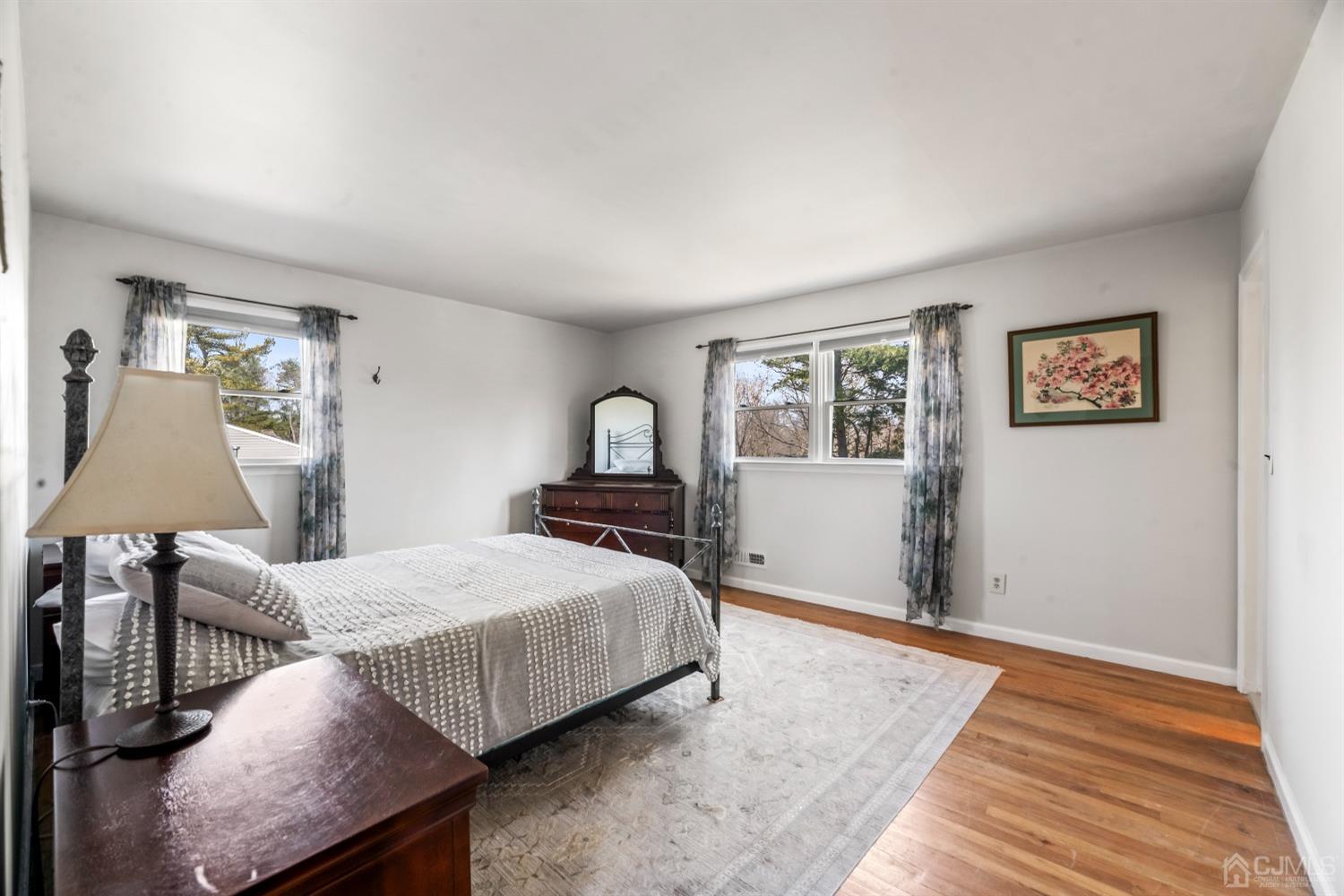 51 Agate Road East Brunswick, NJ 08816 - Photo 12 of 27 a bedroom with a bed and lamp with table