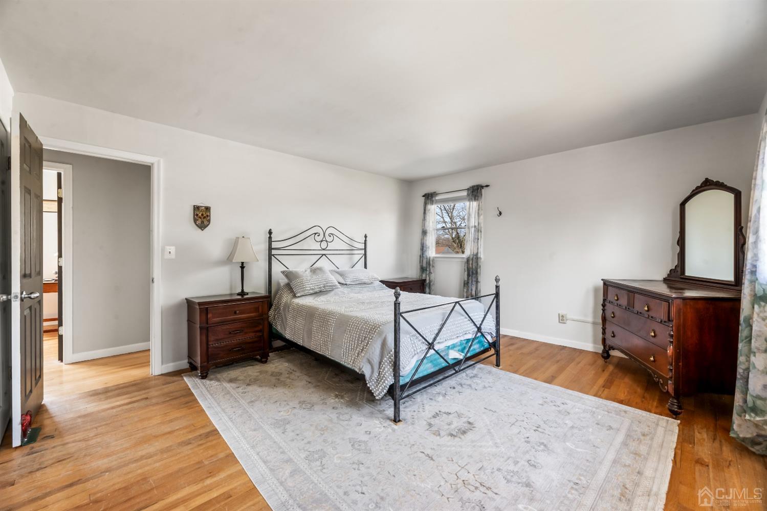 51 Agate Road East Brunswick, NJ 08816 - Photo 13 of 27 a bedroom with a bed and wooden floor