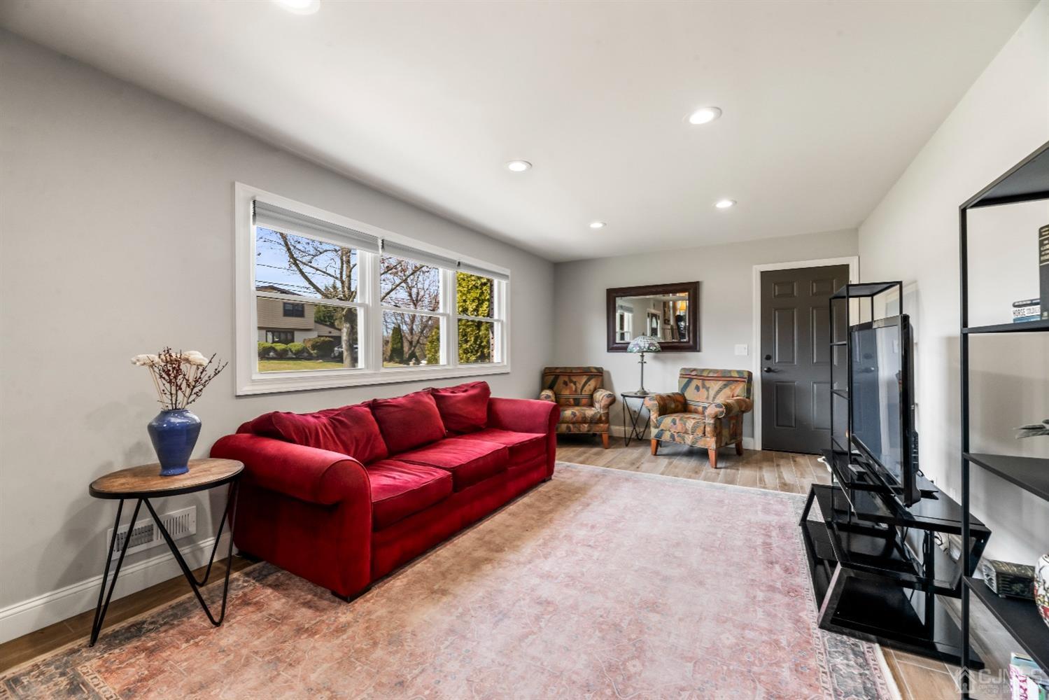 51 Agate Road East Brunswick, NJ 08816 - Photo 4 of 27 a living room with furniture and a flat screen tv
