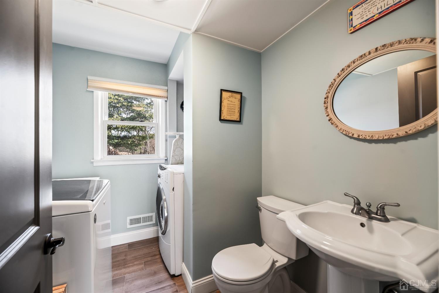 51 Agate Road East Brunswick, NJ 08816 - Photo 6 of 27 a bathroom with a toilet a sink and a mirror