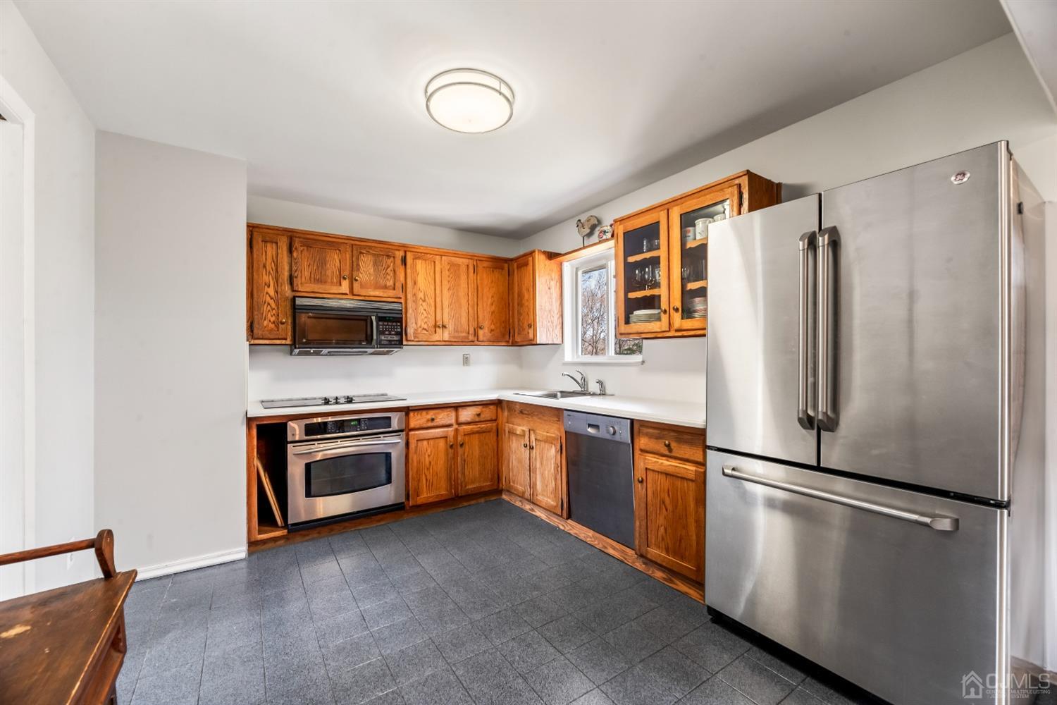 51 Agate Road East Brunswick, NJ 08816 - Photo 10 of 27 a kitchen with stainless steel appliances granite countertop a refrigerator stove top oven and sink
