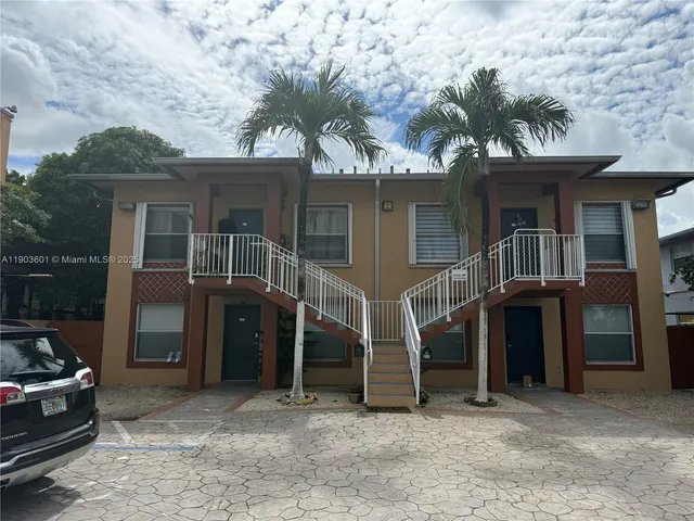 a view of a house with a large tree and a large tree
