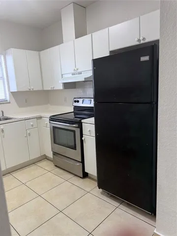 a kitchen with a sink and a refrigerator