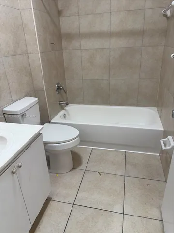 a bathroom with a toilet a sink and bathtub