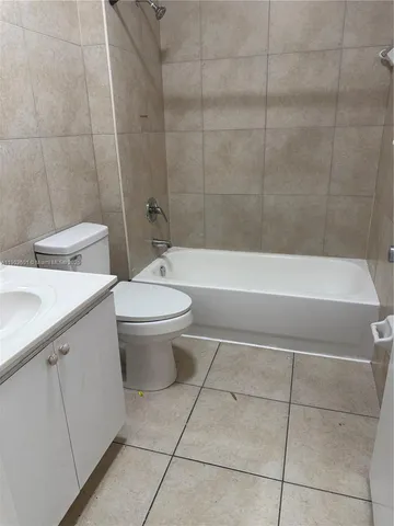 a bathroom with a toilet a sink and bathtub