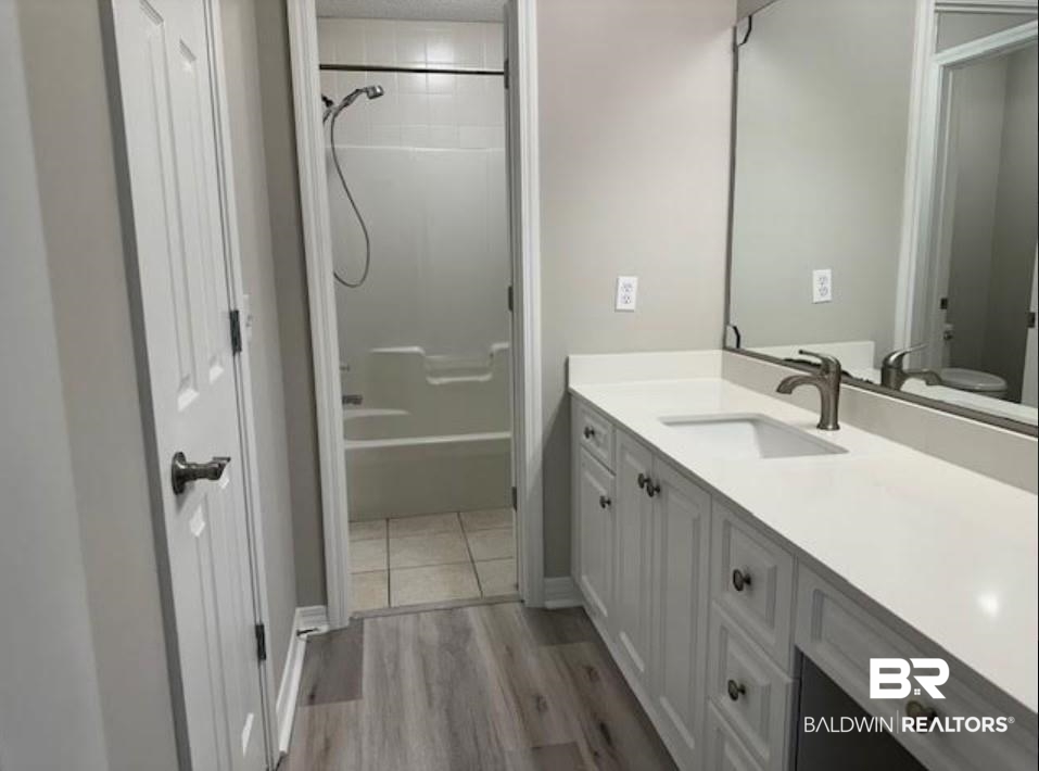 1512 North Cedar Street Foley, AL 36535 - Photo 7 of 13 Full bathroom with toilet, hardwood / wood-style flooring, shower / bathing tub combination, and vanity