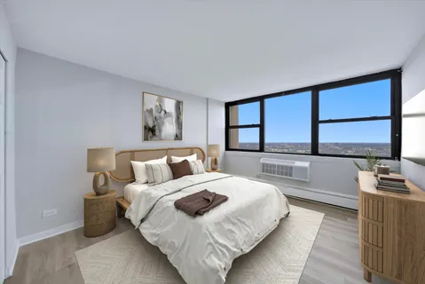 a bedroom with a large bed and a large window