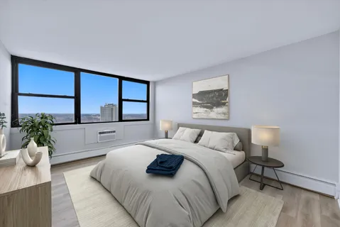 a bedroom with a large bed and a large window