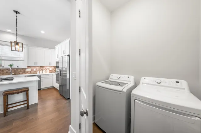a view of washer and dryer with kitchen in the background