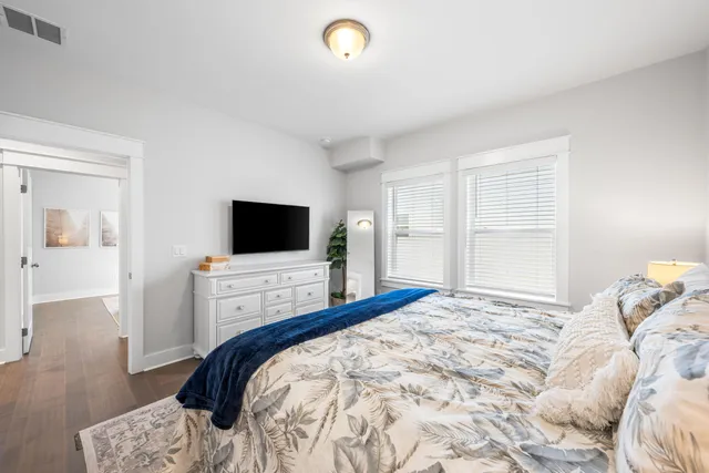 a bedroom with a bed and a flat screen tv