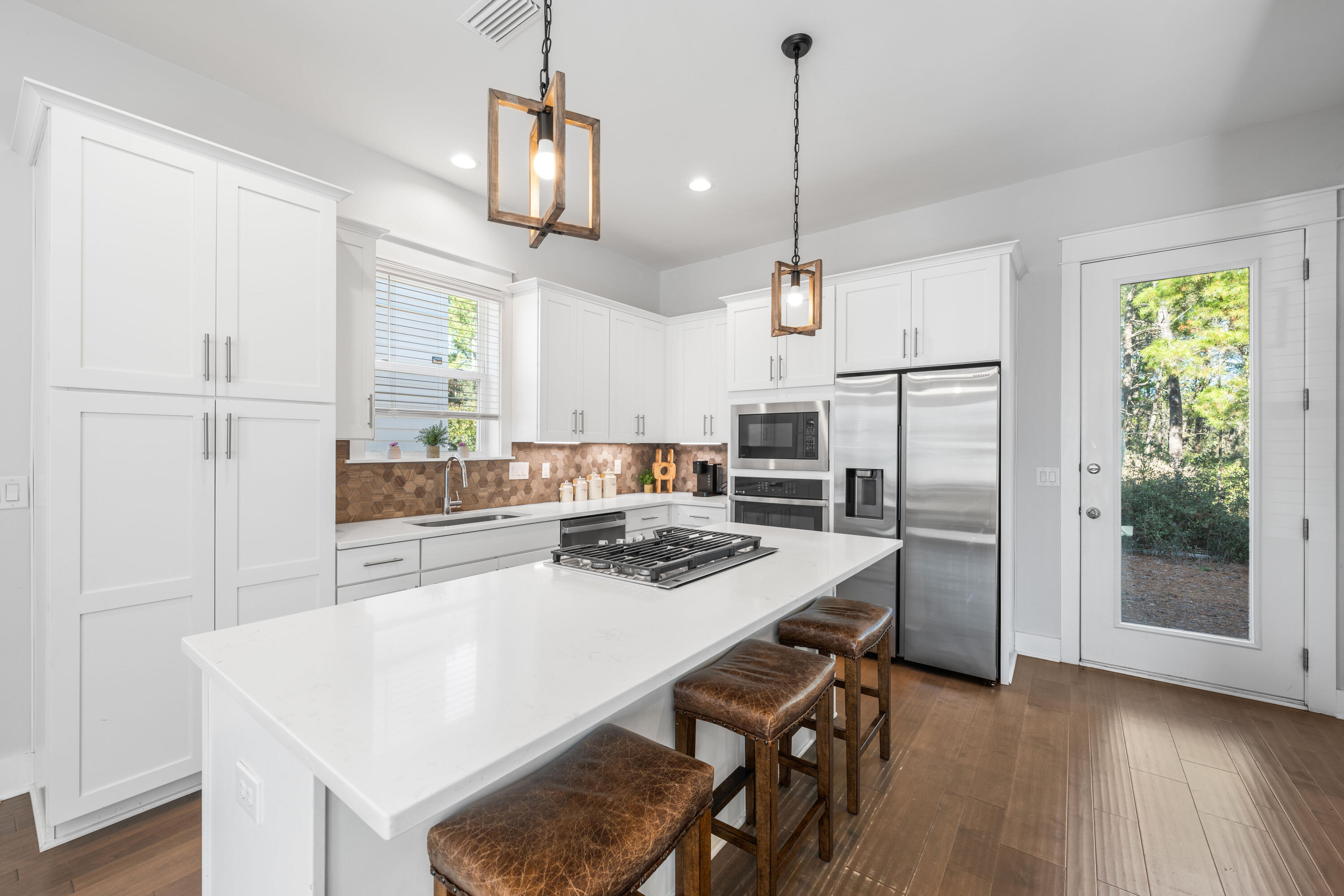 222 Valdare Ln Inlet Beach Inlet Beach, FL 32461 - Photo 3 of 39 a kitchen with kitchen island a table and chairs