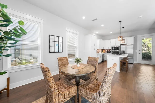 a view of a dining room with furniture and wooden floor