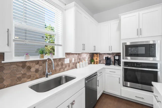a kitchen with a sink and white cabinets