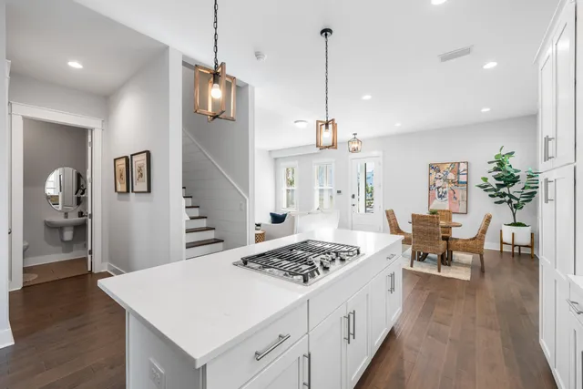 a large kitchen with a table and chairs