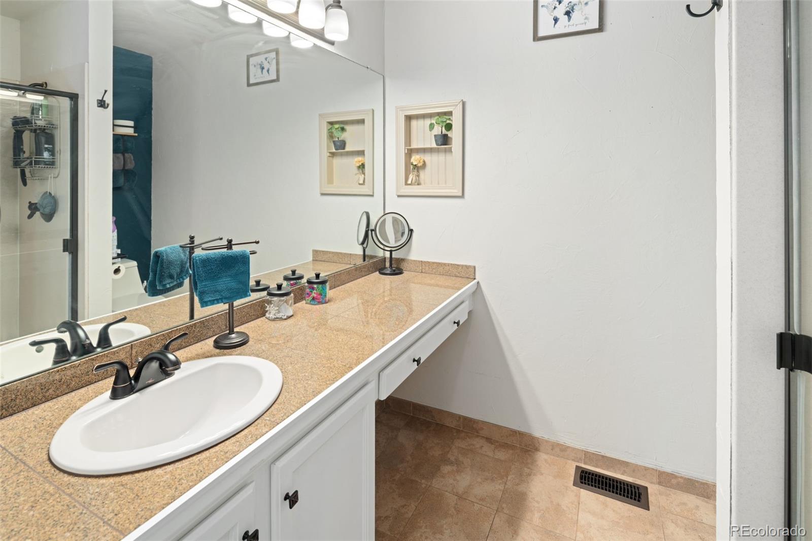 9677 South Castle Ridge Circle Highlands Ranch, CO 80129 - Photo 18 of 24 a bathroom with a sink and a mirror