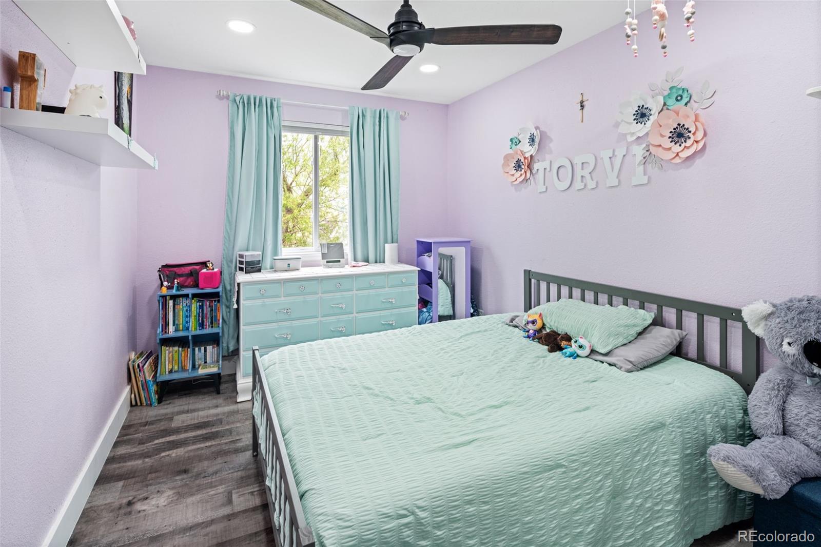 9677 South Castle Ridge Circle Highlands Ranch, CO 80129 - Photo 19 of 24 a bedroom with a bed and a window