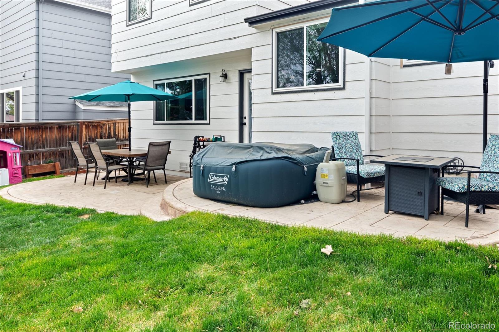 9677 South Castle Ridge Circle Highlands Ranch, CO 80129 - Photo 23 of 24 a view of a patio with table and chairs under an umbrella