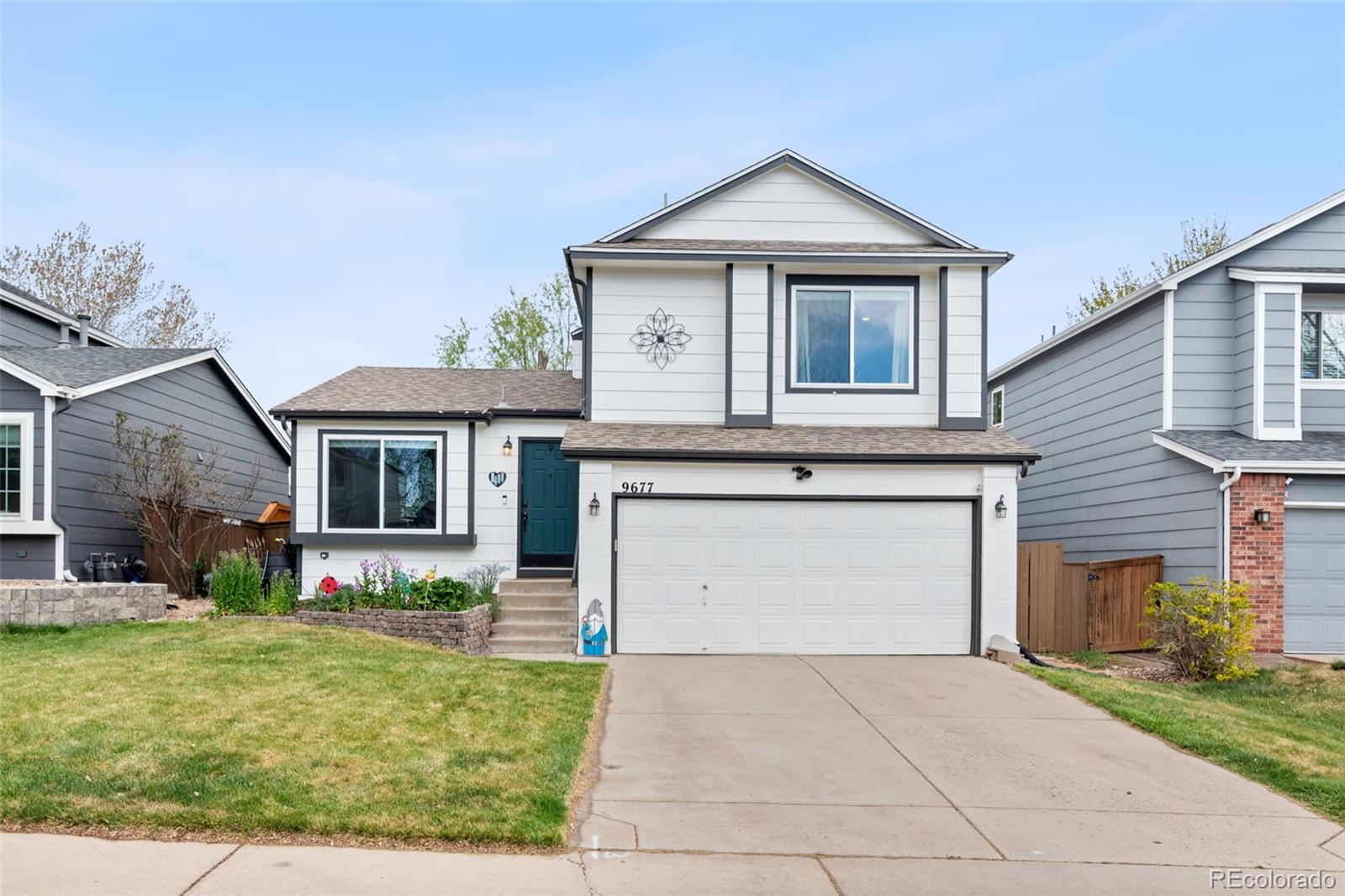 9677 South Castle Ridge Circle Highlands Ranch, CO 80129 - Photo 3 of 24 a front view of a house with garden