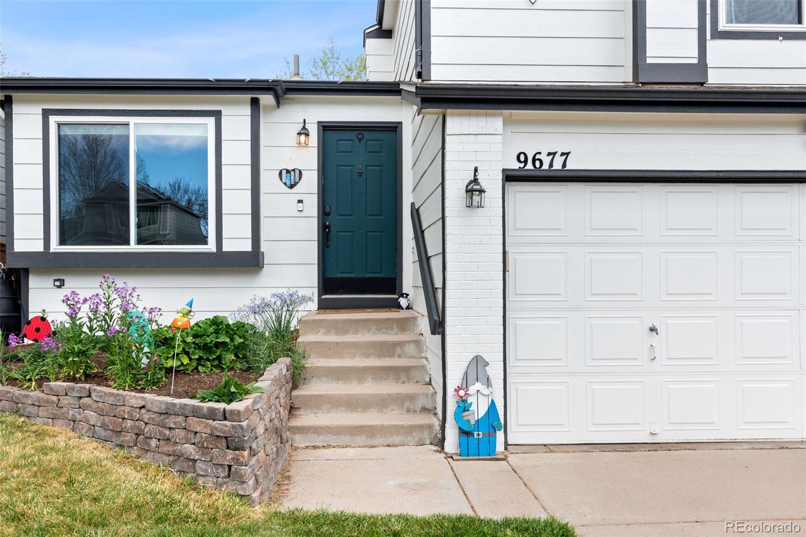9677 South Castle Ridge Circle Highlands Ranch, CO 80129 - Photo 4 of 24 a front view of a house with a garden