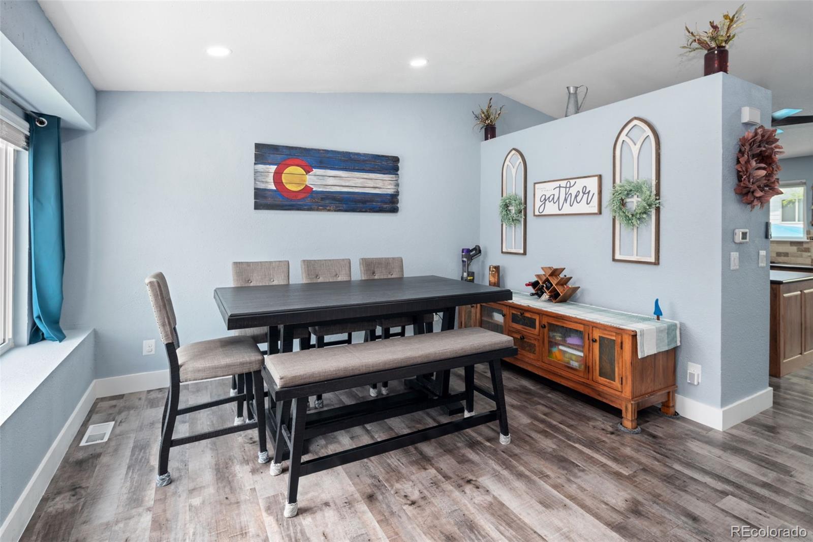 9677 South Castle Ridge Circle Highlands Ranch, CO 80129 - Photo 5 of 24 a living room with furniture a rug and a wall painting