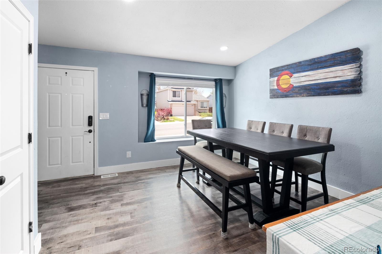 9677 South Castle Ridge Circle Highlands Ranch, CO 80129 - Photo 6 of 24 a view of a dining room with furniture and wooden floor