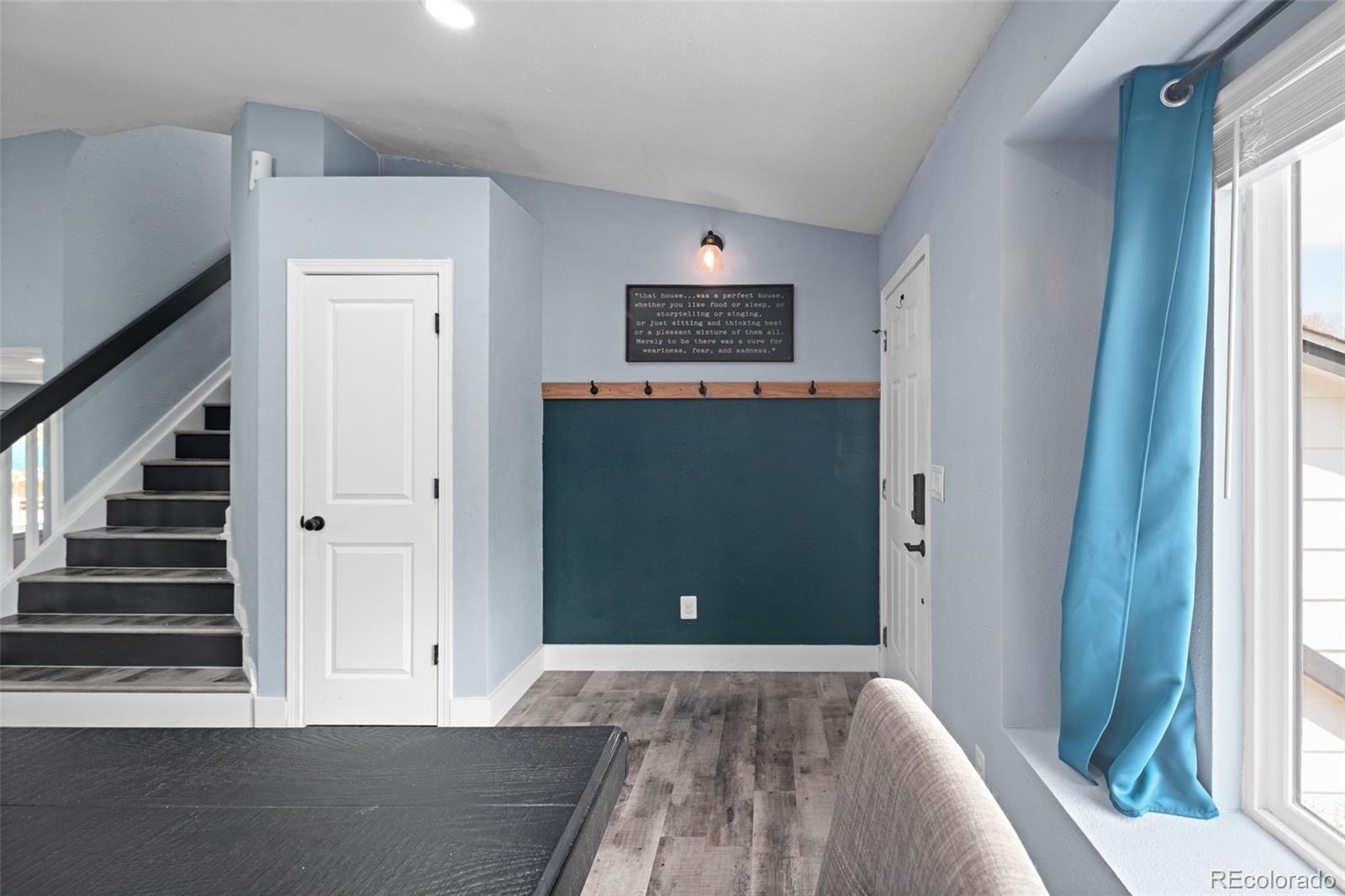 9677 South Castle Ridge Circle Highlands Ranch, CO 80129 - Photo 7 of 24 a view of a livingroom with wooden floor and staircase