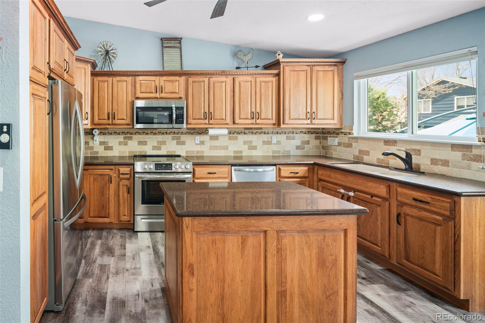 9677 South Castle Ridge Circle Highlands Ranch, CO 80129 - Photo 10 of 24 a kitchen with stainless steel appliances granite countertop a sink stove and refrigerator