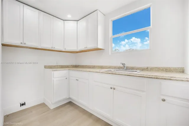 a view of kitchen cabinets and window