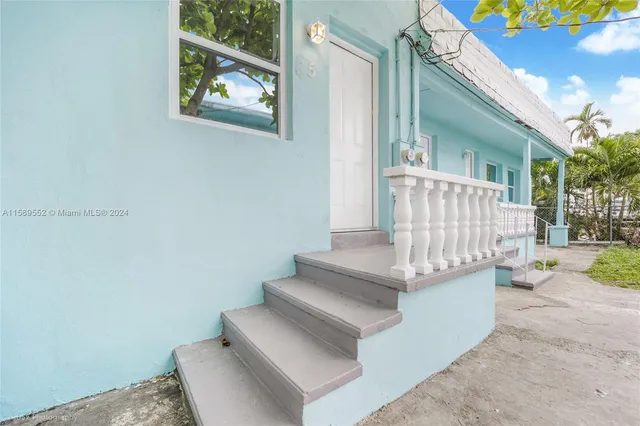 a view of entryway with stairs and a yard