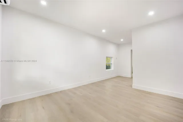 an empty room with a empty space and window