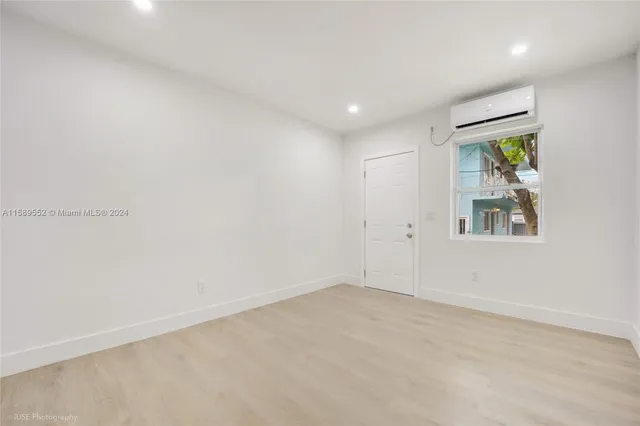 a kitchen with granite countertop white cabinets and stainless steel appliances