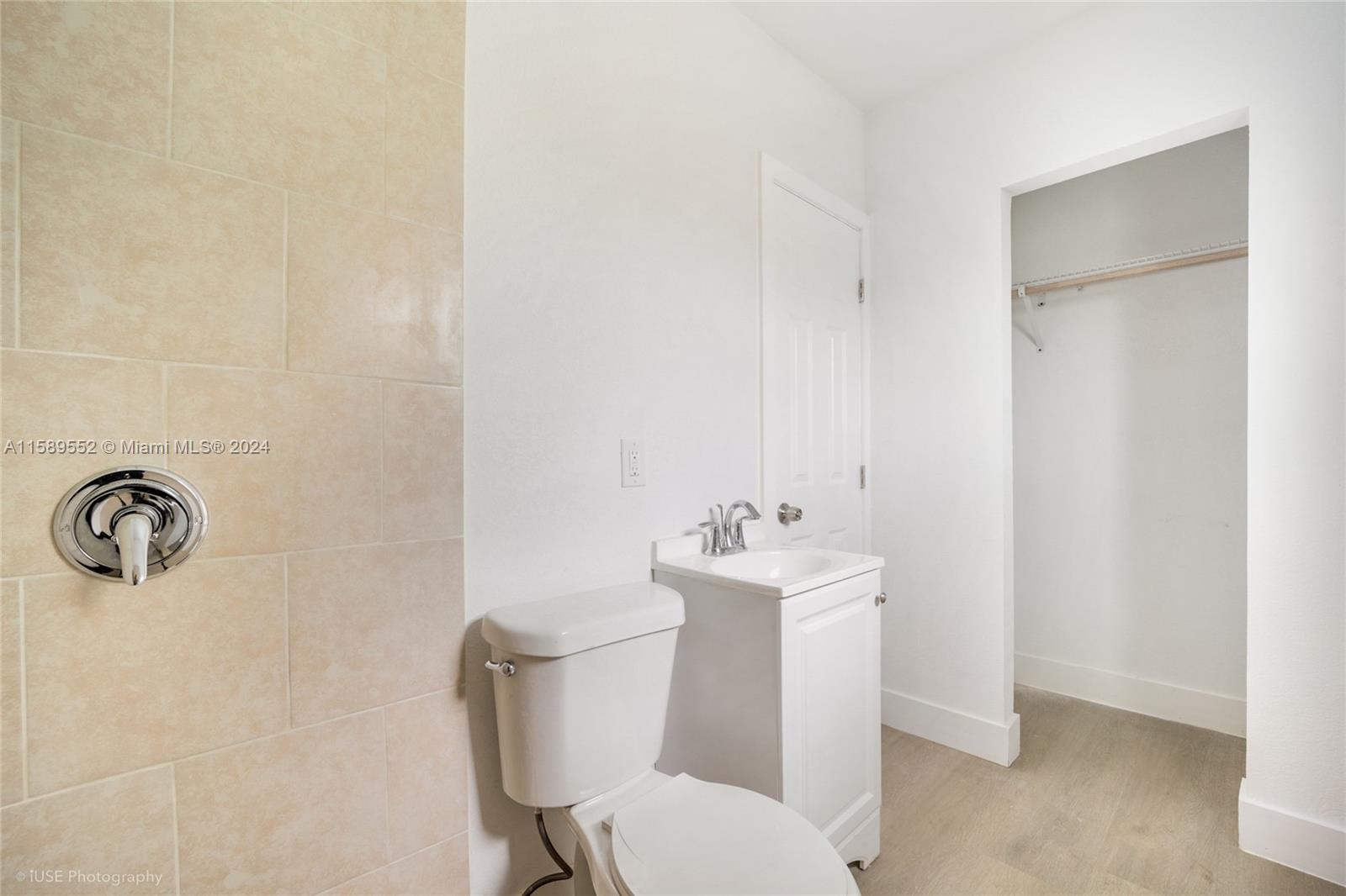 2130 Northwest 28th Street Miami, FL 33142 - Photo 23 of 48 a white toilet sitting next to a bathroom sink