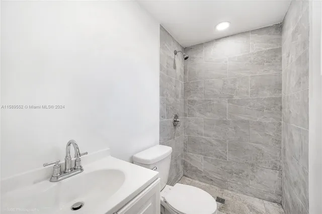 a view of a kitchen with a sink and a refrigerator
