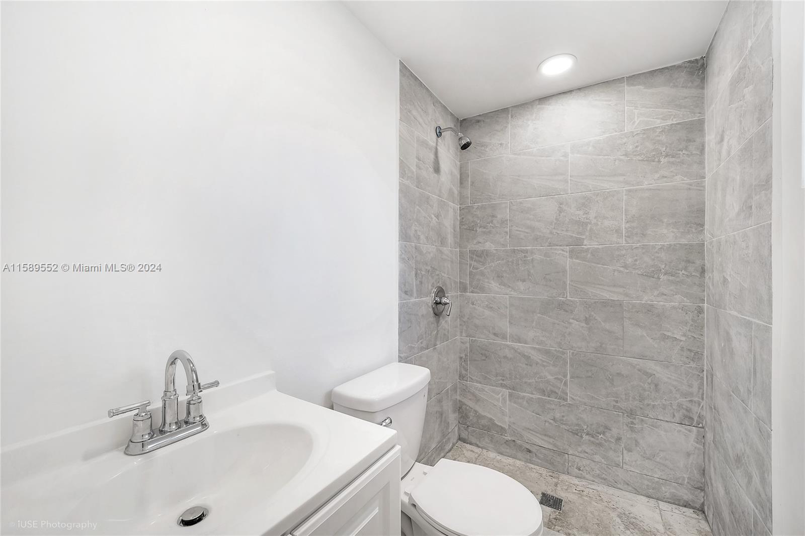 2130 Northwest 28th Street Miami, FL 33142 - Photo 25 of 48 a bathroom with a sink toilet and shower