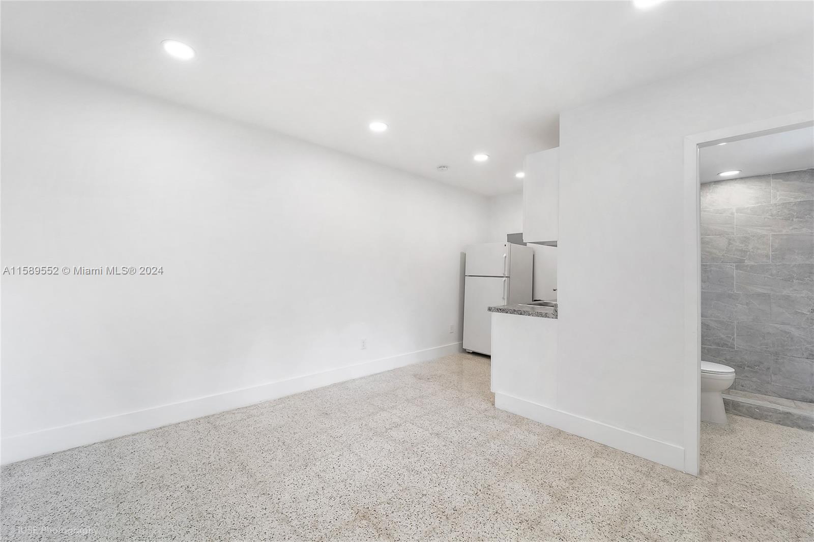 2130 Northwest 28th Street Miami, FL 33142 - Photo 26 of 48 a view of a kitchen with a sink and a refrigerator