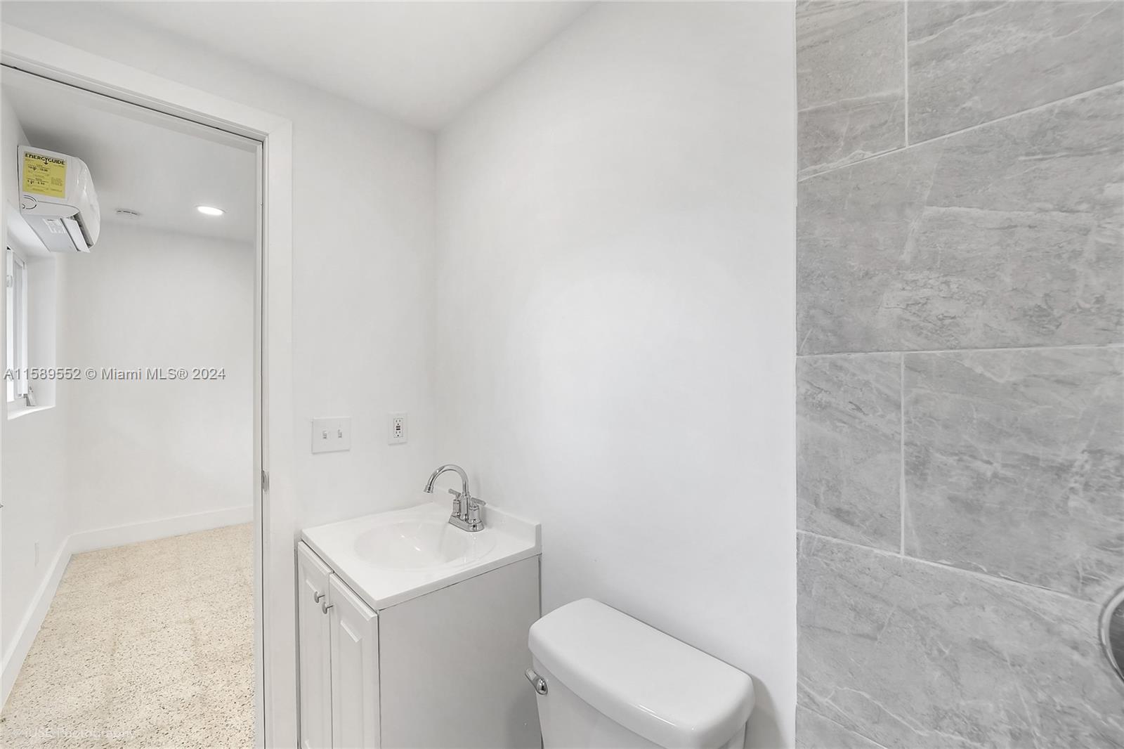 2130 Northwest 28th Street Miami, FL 33142 - Photo 27 of 48 a bathroom with a toilet sink and mirror